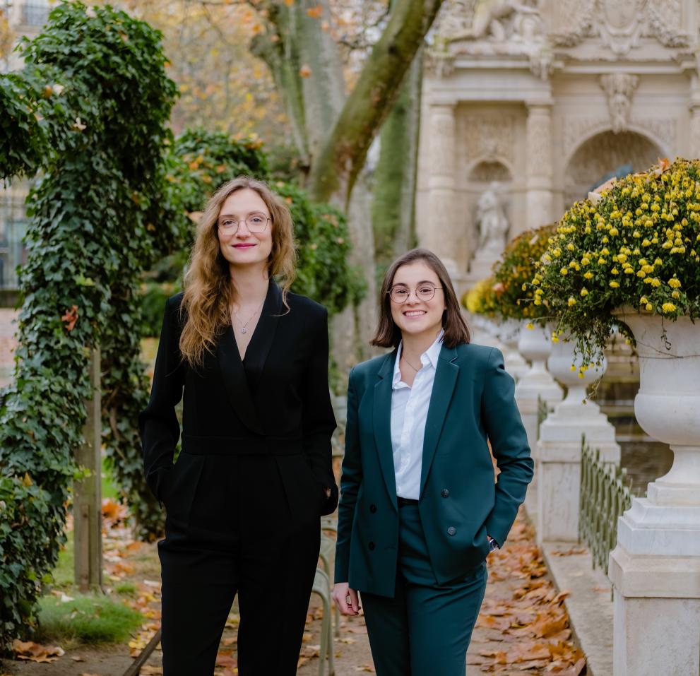 Zuzanna Stamirowska and Claire Nouet  standing in a park with statues and flowers