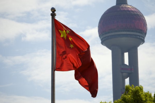 Chinese flag in front of a city tower